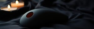 Premium air-pulse and sonic clitoral stimulators on dark silk — luxury adult wellness