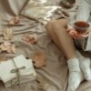 Warm autumn morning scene with soft blanket and tea, evoking quiet self-care and confidence