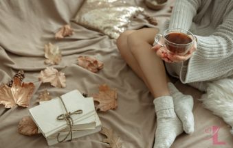 Warm autumn morning scene with soft blanket and tea, evoking quiet self-care and confidence